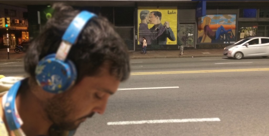 Lulo at night in front of his tango mural on a city street